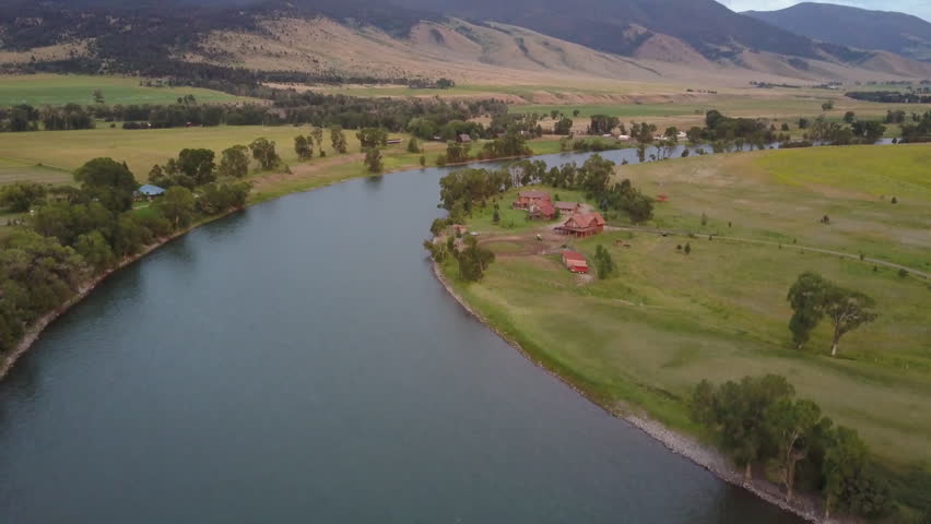 Aerial shot flying over the Yellowstone River in the beautiful Paradise Valley, Montana, during a colourful sunset