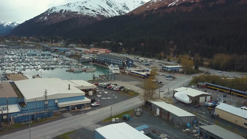 Aerial view of Seward small boat harbor and mountains. Alaska, USA. 4k
