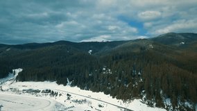 Beautiful Carpathian mountains,aerial drone footage.Mountain park shot from above with flying camera in cold winter day