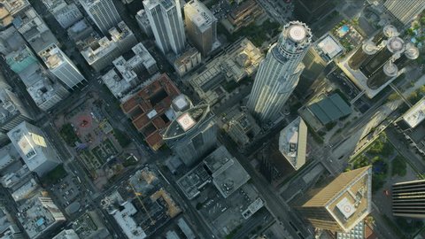 Aerial overhead view streets and buildings downtown LA with commercial skyscraper rooftop heliports towers California USA RED WEAPON