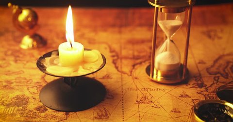 old nautical navigation items with candle on vintage map (there is no intellectual property infringes, world map is free to use)