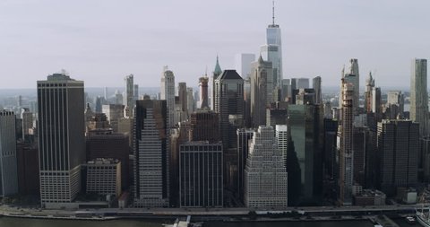 80s Establishing shot aerial view of Manhattan skyline skyscrapers in New York during the day under blue skies. Wide shot on 4K RED camera.