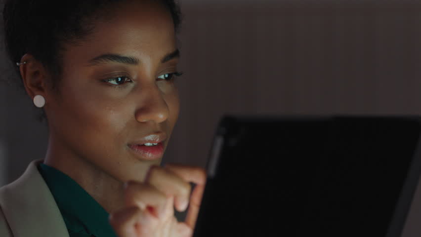 beautiful business woman using tablet computer working late in office browsing information looking at data on digital touchscreen Royalty-Free Stock Footage #1025150819