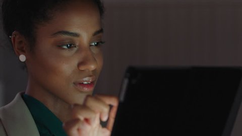 beautiful business woman using tablet computer working late in office browsing information looking at data on digital touchscreen