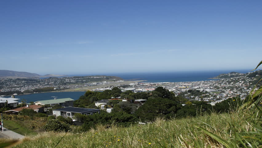 Timelapse over Wellington bay in New Zealand with a bright blue sky.