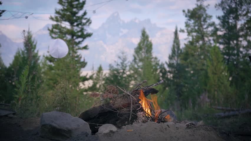 Campfire with a beautiful backdrop of the Grand Teton in Wyoming. This National Park sits across from Shadow Mountain where this campsite resides.