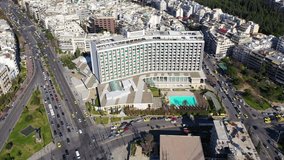 Aerial drone bird's eye view video of famous Athens landmark hotel, the Hilton in city centre, Attica, Greece