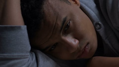 Depressed afro-american teenager thinking about life problems, mental health