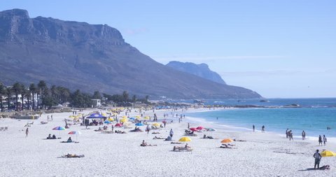 Colorful time lapse of busy beach in Camps Bay Capetown