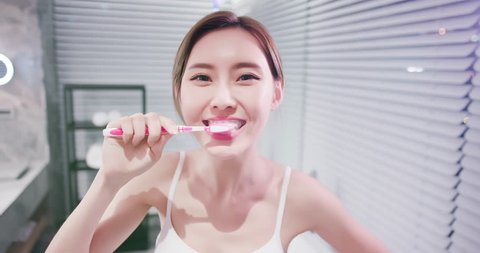 pretty woman brush her healthy teeth happily