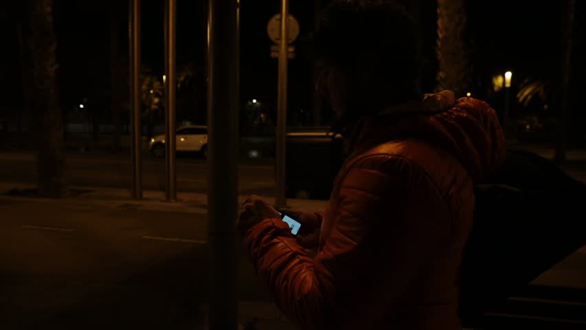 Man looking at his cell at night