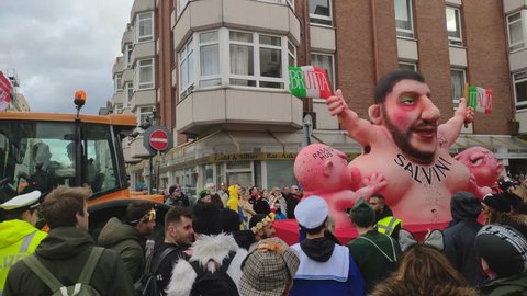 Dusseldorf, Germany - March 3, 2019. Traditional street carnival. Unidentified people cheering carnival floats and traditional groups at the street parade. Float showing Matteo Salvini with babies