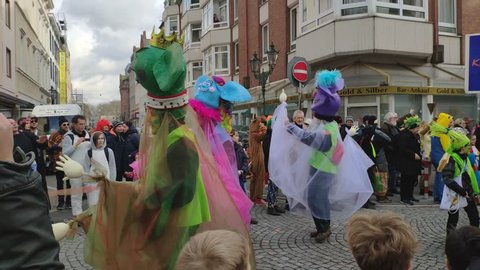 Dusseldorf, Germany - March 3, 2019. Traditional street carnival. Unidentified people cheering carnival floats and traditional groups at the street parade. kids in costumes