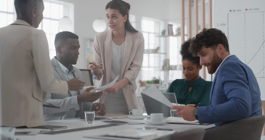Corporate business team meeting manager woman brainstorming with colleagues discussing project strategy sharing ideas in office | Shutterstock HD Video #1025206628