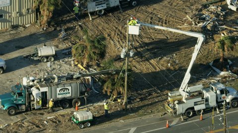 Florida - November 2018: Aerial view emergency Utility services trucks people affecting repairs along Mexico Beach after Hurricane Michael swept in Florida America RED WEAPON