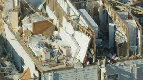 Aerial view of Hurricane Landfall devastation catastrophic damage to property walls and roofs ripped away exposing household contents people left homeless RED WEAPON
