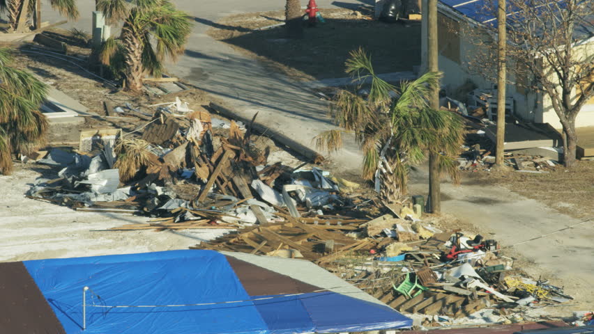 Aerial view of damage done to property by severe Hurricane Landfall destroying and leaving a community devastated and many people homeless America RED WEAPON