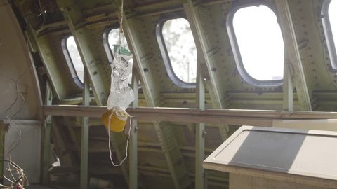 The old oxygen mask on the plane cabine. Handheld shot with selective focus. Catastrophe,airplane crash and