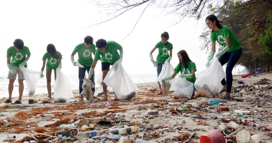 Group of asian people cleaning up the beach with plastic bags full of garbage. People with environment and volunteering concept. 4k resolution. Royalty-Free Stock Footage #1025209217