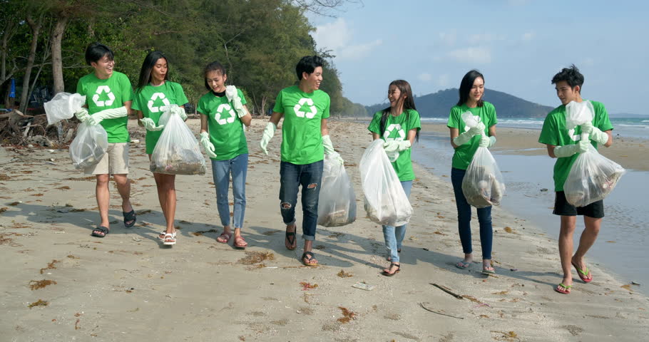 Group of asian people cleaning up the beach with plastic bags full of garbage. People with environment and volunteering concept. 4k resolution. Royalty-Free Stock Footage #1025209223
