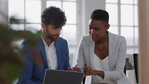 african american black business woman team leader brainstorming with colleague using laptop computer showing ideas pointing at screen working together in office