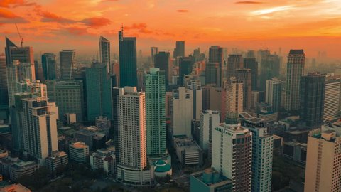 Sunset of background Skyscrapers of Makati distric in Manila the capital of the Philippines. Aerial Drone Timelapse 4K