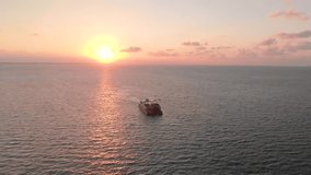 Aerial footage of a passenger and car ferry that goes between Isla Mujeres and Cancun in Mexico at sunrise.