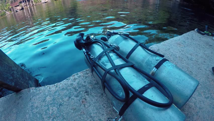 A pair of scuba tanks next to the swimming pool of El Jardin del Eden cenote in Mexico.