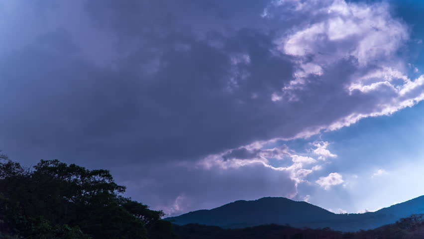 Magical sunset, wavy clouds fading to black