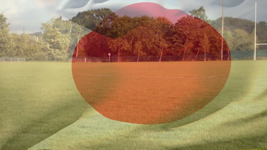 Digital composite of digitally generated japan national flag against football stadium