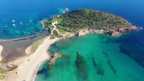 Aerial drone video of famous small islet with picturesque chapel of Agios Nikolaos and small marina, Anavissos area, Attica, Greece