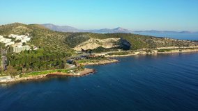 Aerial drone, bird's eye view video from iconic lake Vouliagmeni famous for healing abilities, Athens riviera, Attica, Greece