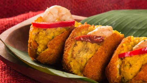 Acaraje - Traditional Brazilian fritters made with black-eyed peas filled with vatapa, caruru, pepper and sauteed shrimp with smoke. Typical food from Bahia.