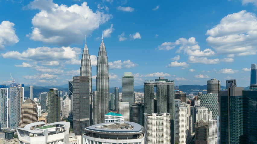 Aerial view of Kuala Lumpur Downtown, Malaysia. Financial district and business centers in smart urban city in Asia. Skyscraper and high-rise buildings at noon with blue sky.