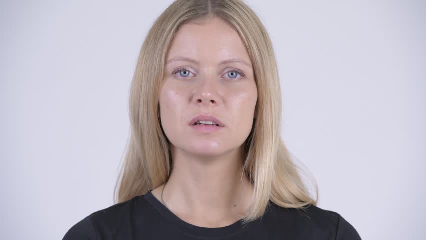 Face of young sad blonde woman looking down and crying