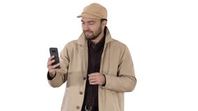 Young man making a video call from his mobile phone while walking on white background.