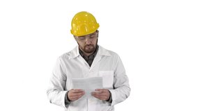 Site engineer cheching papers and something around him on white background.