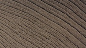 Furrows made by tractor plough from above 4K drone video