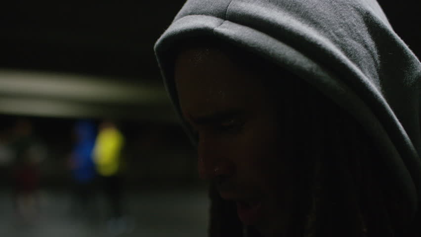 Mixed race man with dreadlocks getting his breath back after a workout