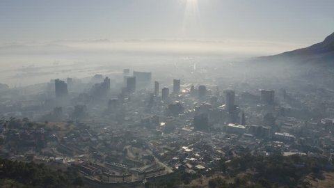 Climate emergency. Climate change. Global warming.Epic view of smog and pollution hanging over Cape Town City centre, harbour and surrounding suburbs at sunrise