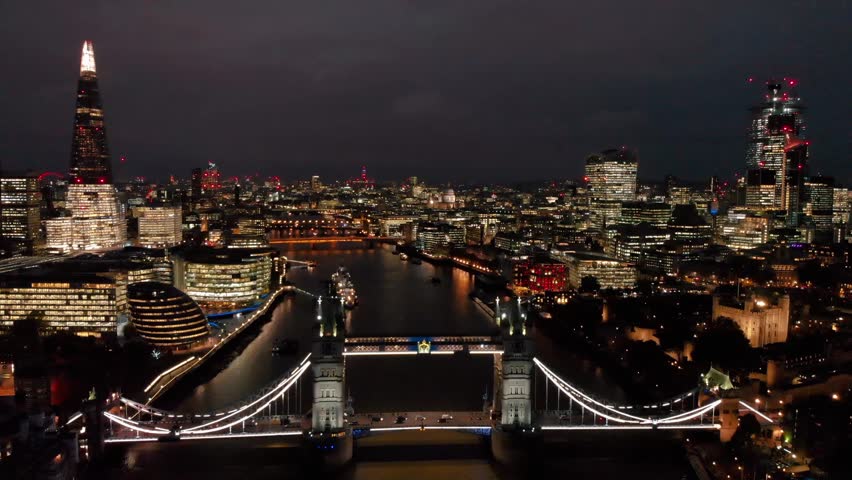 London, Kingdom- 11.05.2016: Aerial Drone  Close Up Tower Bridge The Shard Building Thames River Traffic Cars London Skyline Lights At Night