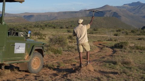 AFRICA,SOUTH AFRICA,CIRCA 2019.4K view of a game ranger using a tracking device to track collared animals in a game reserve