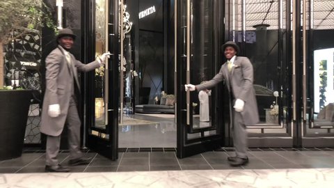 DUBAI - OCTOBER, 2018: Fashion Avenue entrance with chauffeur opening door at the Dubai Mall, the second-largest mall in the world by total land area.