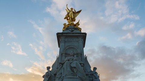 LONDON, UK - 01.30.2019: Victoria Memorial Sunset Evening Time-Lapse with the Buckingham Palace in the background. 
Blue sky with yellow clouds sunset.
