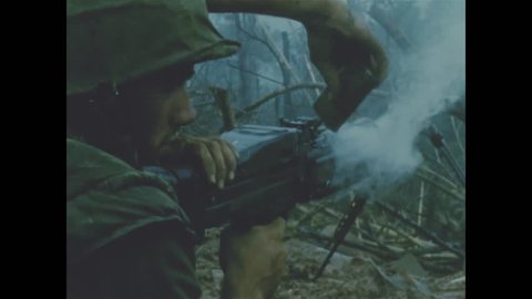 CIRCA 1960s - A grenade is thrown and a machine gun is fired as well as a mortar as United States Marine Corps engage in jungle combat.
