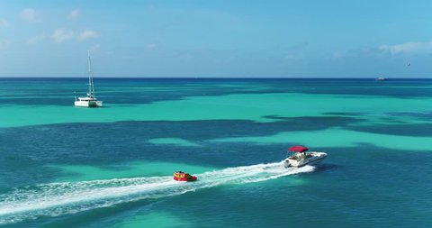 Palm Beach, Noord, Aruba - June 20 2016: Aerial of Speed Boat Tubing in Tropical Ocean Water, Caribbean
