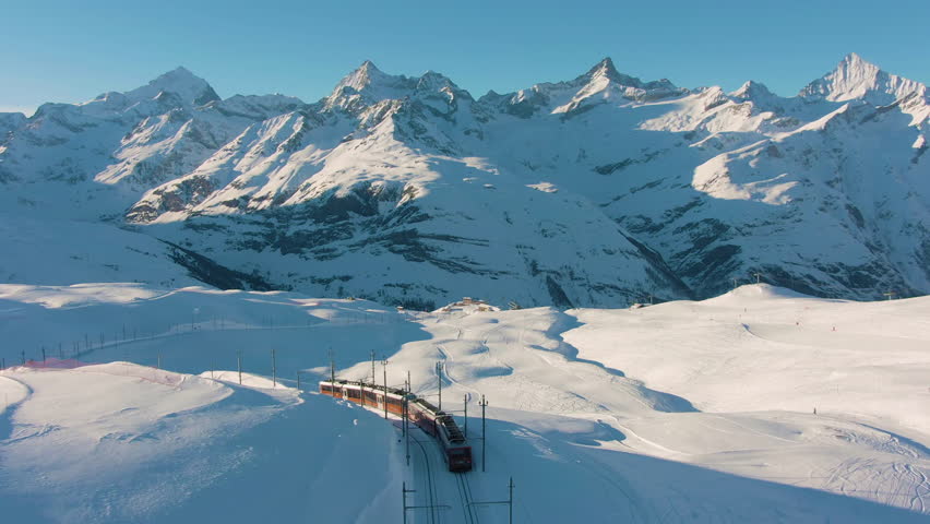 Matterhorn Mountain and Gornergrat Train in Winter at Sunset. Swiss Alps. Switzerland. Aerial View Royalty-Free Stock Footage #1025295923