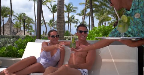 Couple Drinking Poolside on Bed With Tropical Drinks, Resort Pool