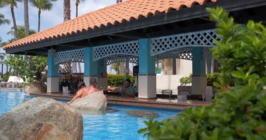 Couple Drinking at Pool Bar, Tropical Beach Resort Poolside