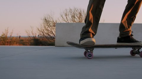 Cool professional skateboarder tries to make trick on skateboard in skatepark or sidewalk, fails and falls on ground, rolls over. Saves it by standing up. Concept fall but get back up Video Stok